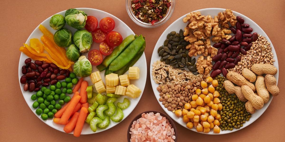 Vibrant display of assorted vegetables, legumes, nuts, and seeds on plates, perfect for healthy eating images.